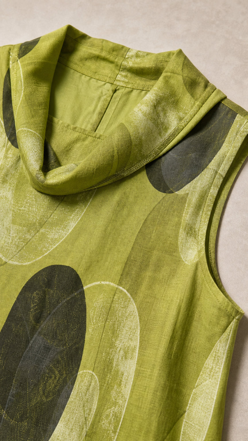 Close-up detail of green cowl neckline and fabric texture