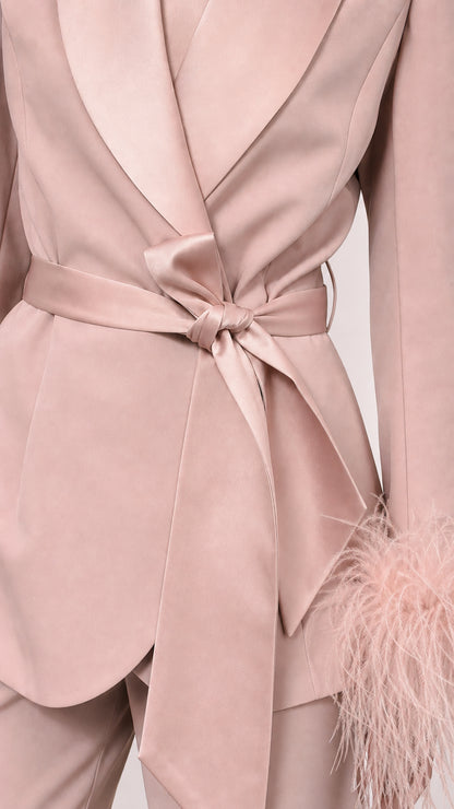 Close-up of pink satin blazer wrap tie and lapel detail