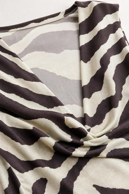 Close-up detail of the cowl neck and smooth fabric