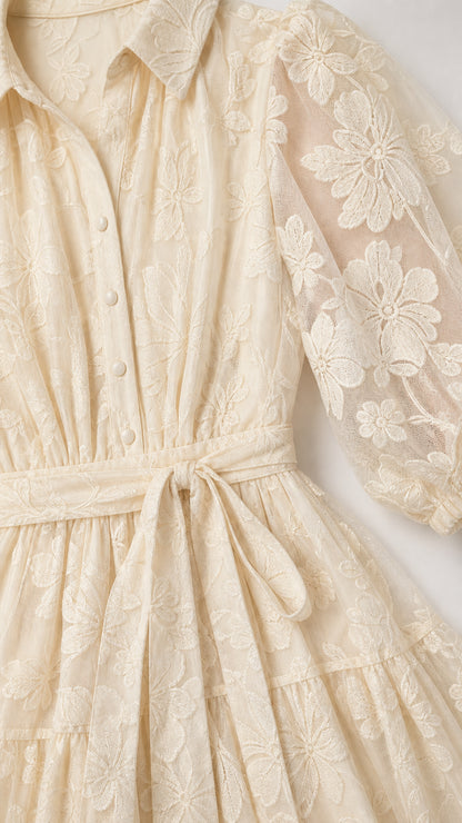 Close-up detail of shirt collar, buttons, and sheer floral embroidery