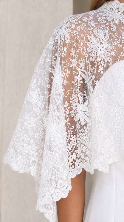 Close-up detail of White floral lace overlay and sleeve