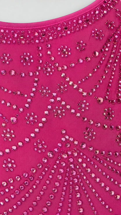 Close-up detail of rhinestone and bead pattern on hot pink fabric
