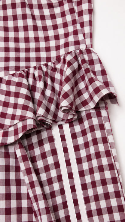 Close-up of peplum ruffle and side stripe detail on burgundy set