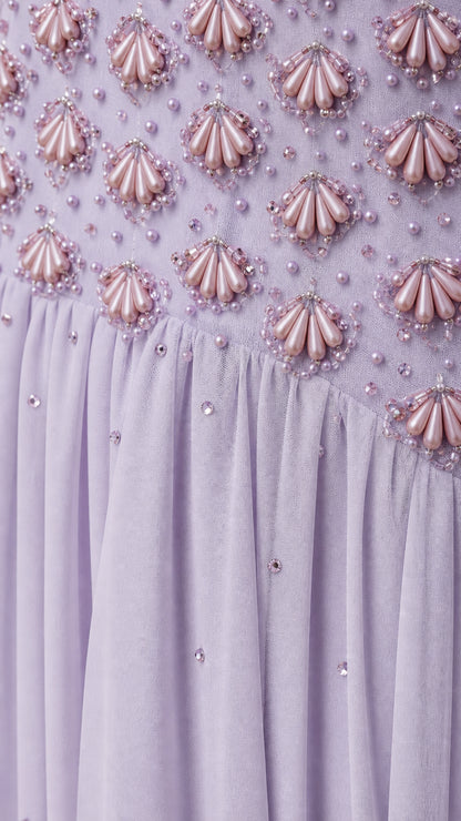 Close-up detail of beaded bodice and textured embellishments