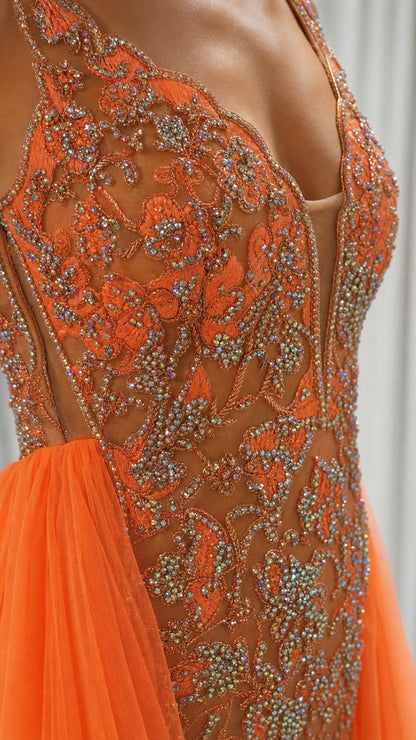 Close-up detail of the intricate beadwork and illusion V-neckline on the bodice
