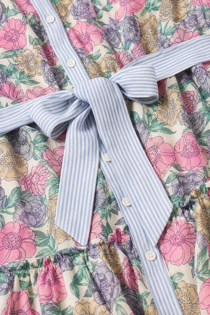 Close-up detail of button-front placket and striped sash tie