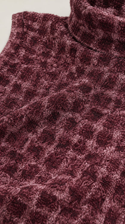 Close-up of fabric texture and mock neck detail in burgundy