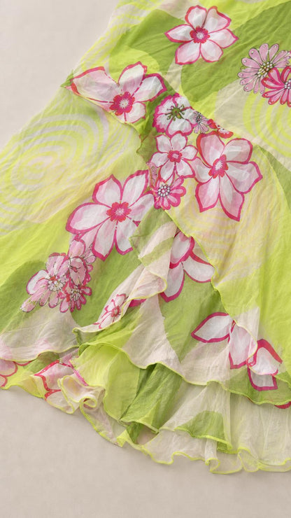 Close-up of lightweight textured fabric and ruffle hem with floral print