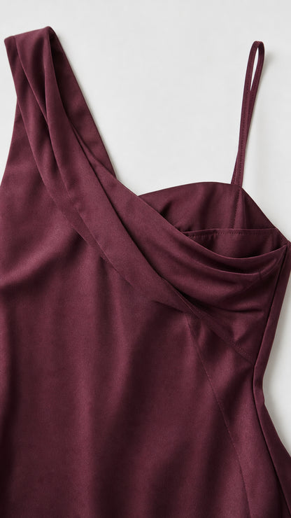 Close-up detail of one-shoulder strap and draped cowl neckline