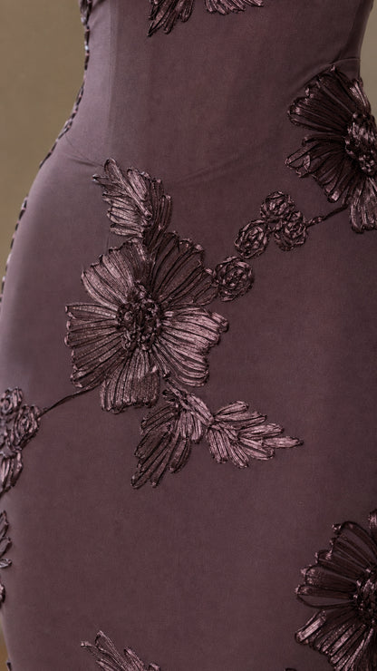 Close-up of dimensional floral embroidery on burgundy dress