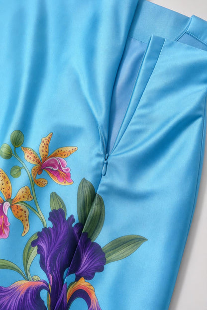 Close-up of blue dress fabric and floral hem detail
