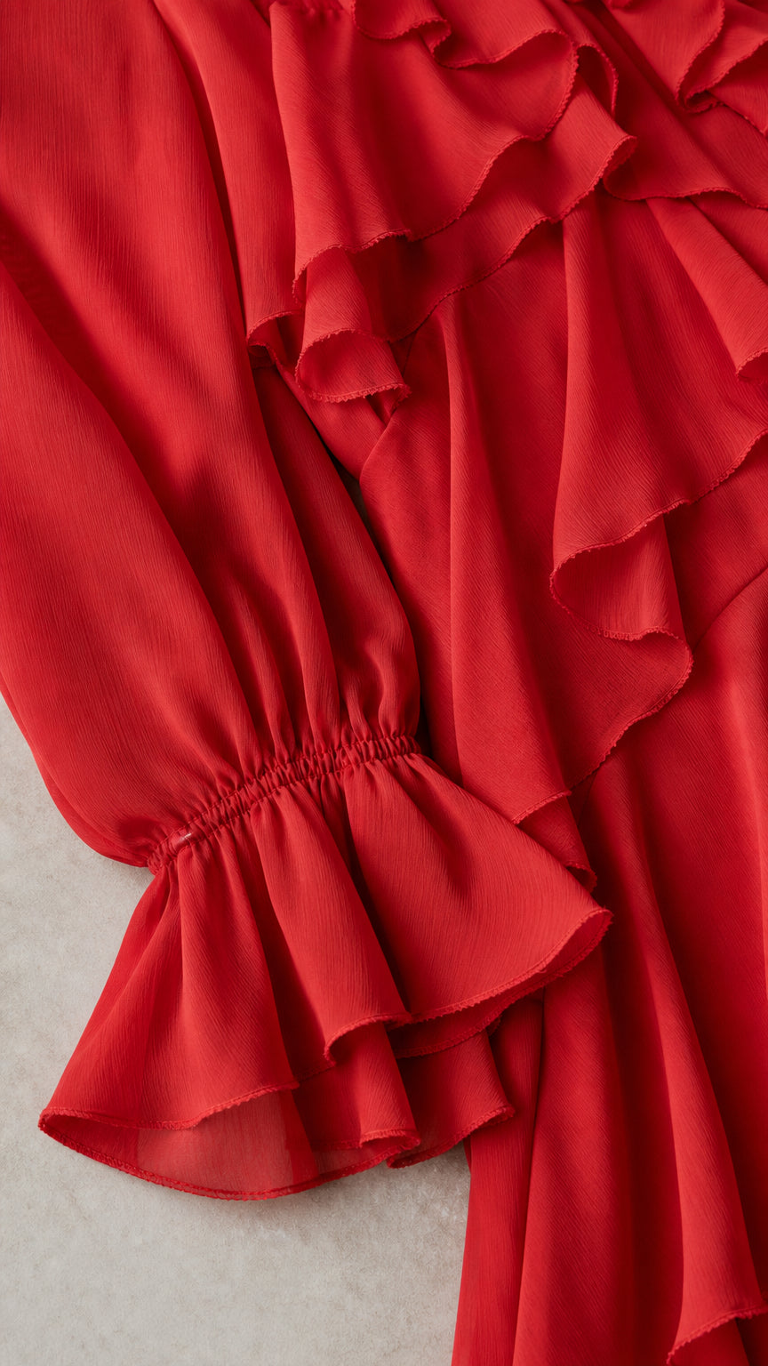 Close-up of red dress sleeve and ruffle details