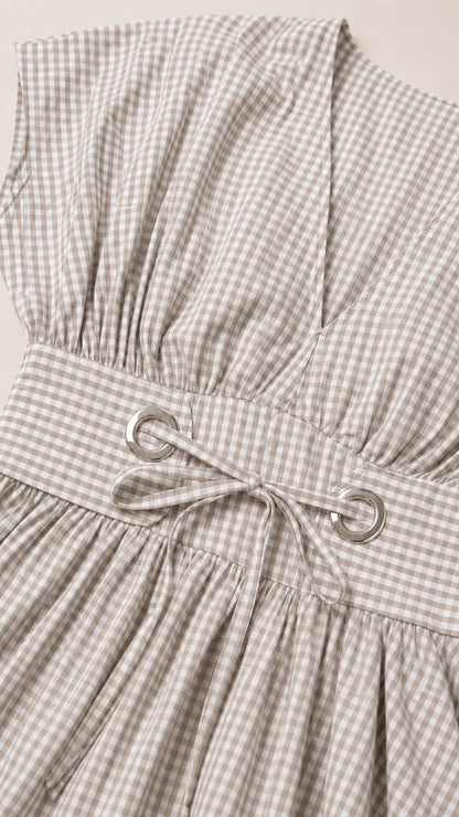 Close-up of bodice, grommet tie waist, and gingham fabric texture