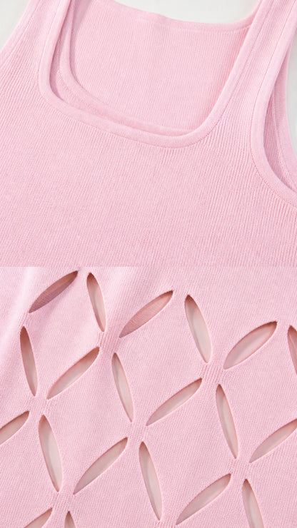 Close-up detail of square neckline and hem cutouts on pink dress