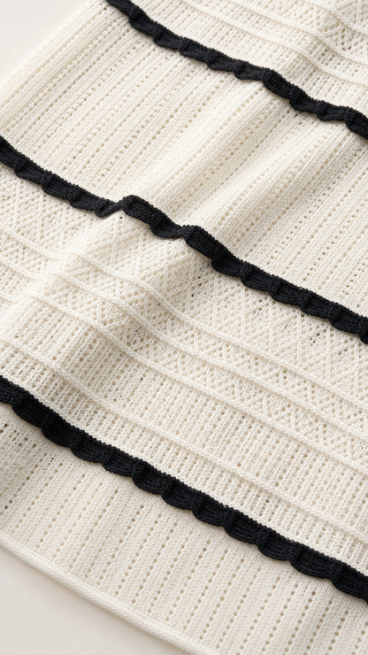 Close-up detail of white and black striped ribbed knit fabric