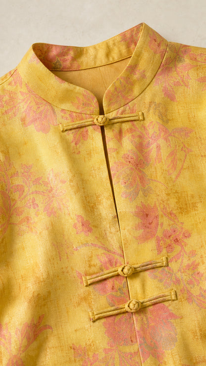 Close-up detail of yellow top showing Mandarin collar and frog buttons
