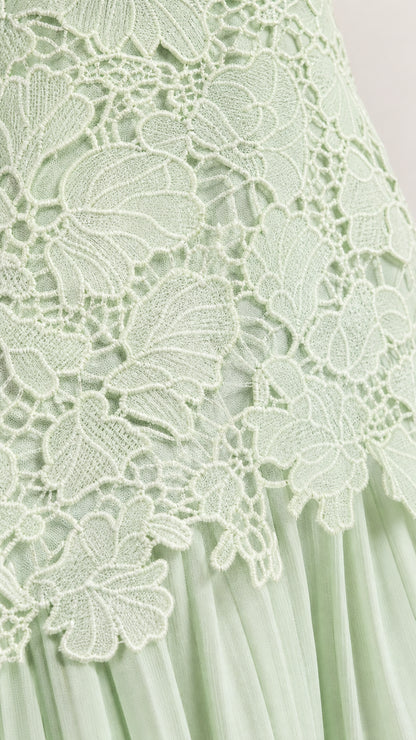 Close-up detail of floral lace applique and pleating on Sage Green dress
