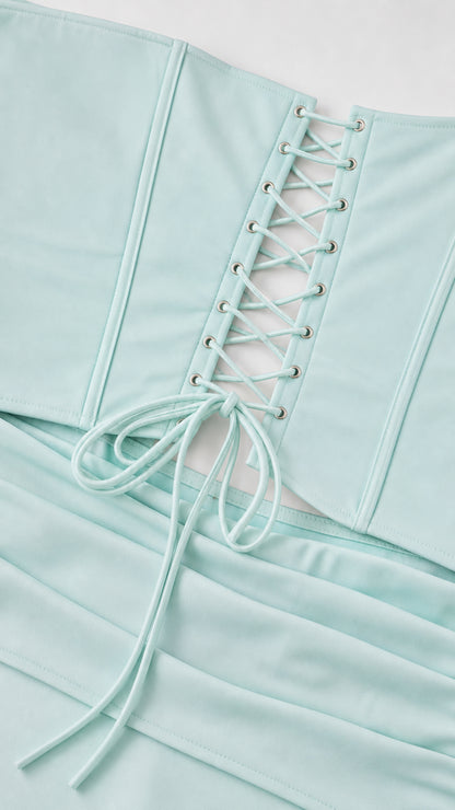 Close-up detail of lace-up corset back and smooth fabric