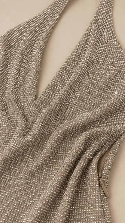 Close-up fabric texture detail of shimmering rhinestone halter dress