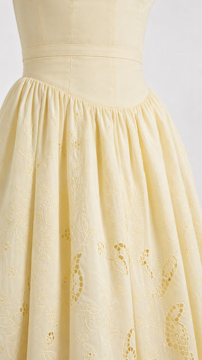 Close up detail of yellow embroidered skirt and fitted waist