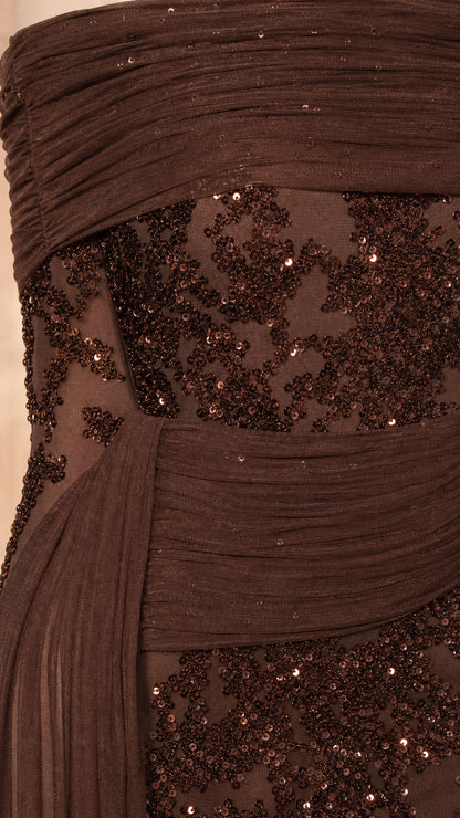 Close up of pleated bodice and sequin detail on brown evening gown