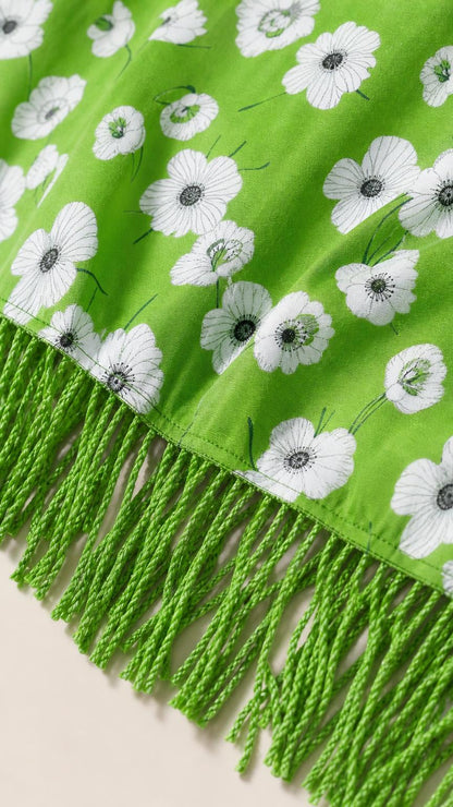 Close-up of green floral fabric and matching fringe hem detail