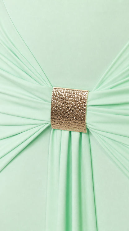 Close-up of gold metallic buckle gathering fabric on the dress