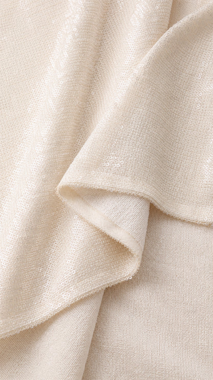 Close-up detail of smooth shimmering champagne fabric texture