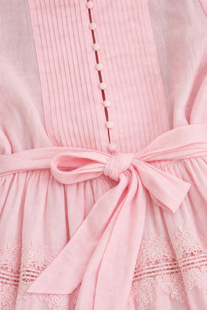 Close-up of bodice, buttons, and waist tie on pink dress