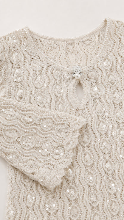 Close-up of fabric texture and keyhole neckline on white dress