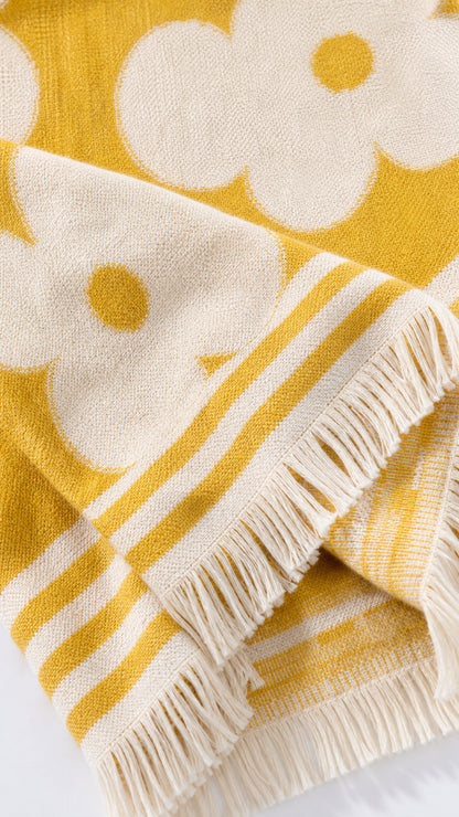 Close-up of yellow and white jacquard fabric texture and fringe