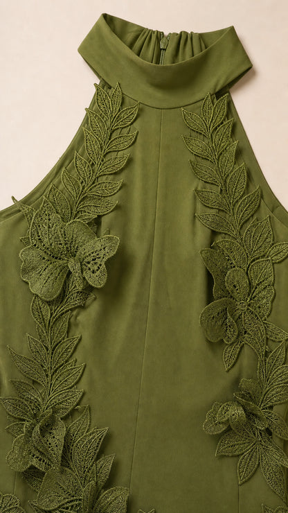Close-up detail of halter neckline and 3D leaf appliques in olive