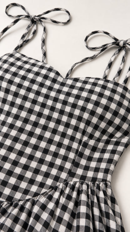 Close-up of fabric texture and tie straps on gingham dress