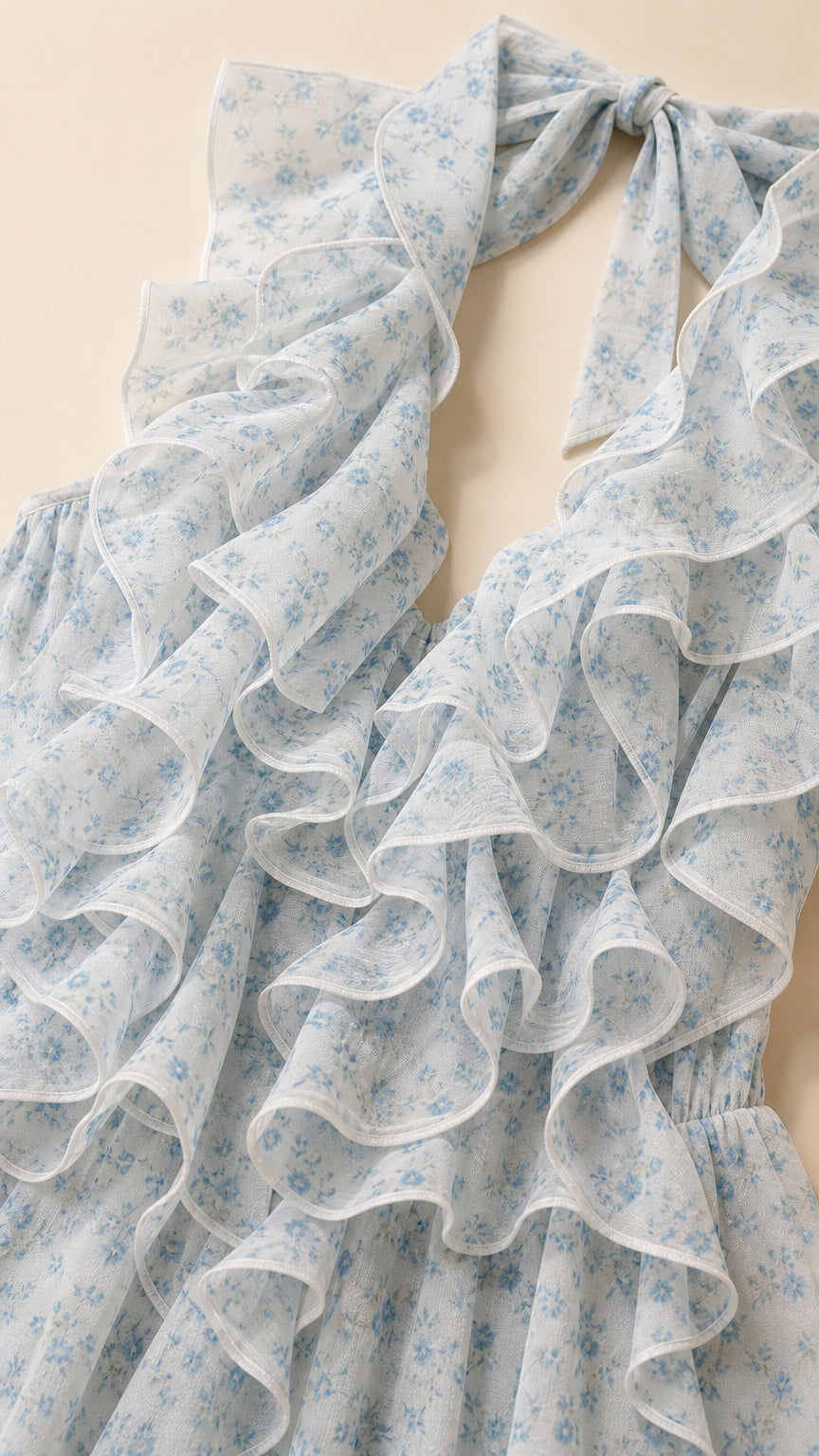 Close-up of the pale blue floral fabric and cascading ruffle detail