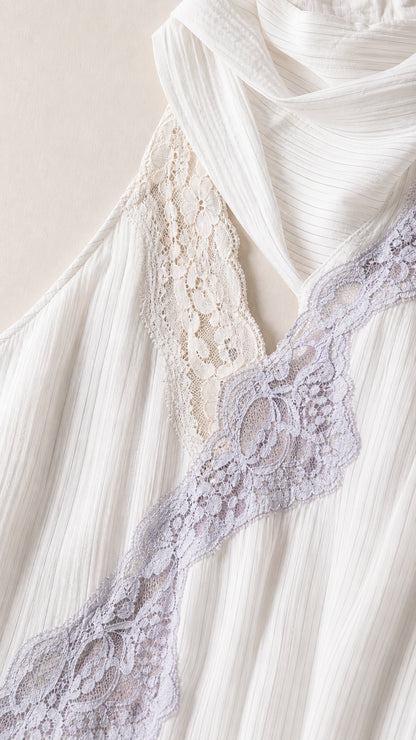 Close-up detail of diagonal lace trim on textured white fabric
