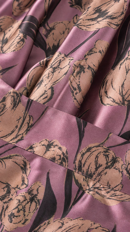 Close-up detail of the purple and metallic floral jacquard fabric