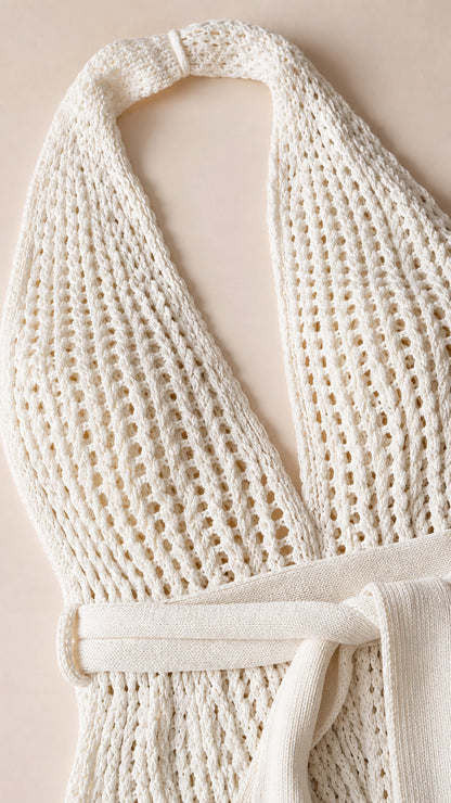 Close-up detail of ivory knit texture and tie belt