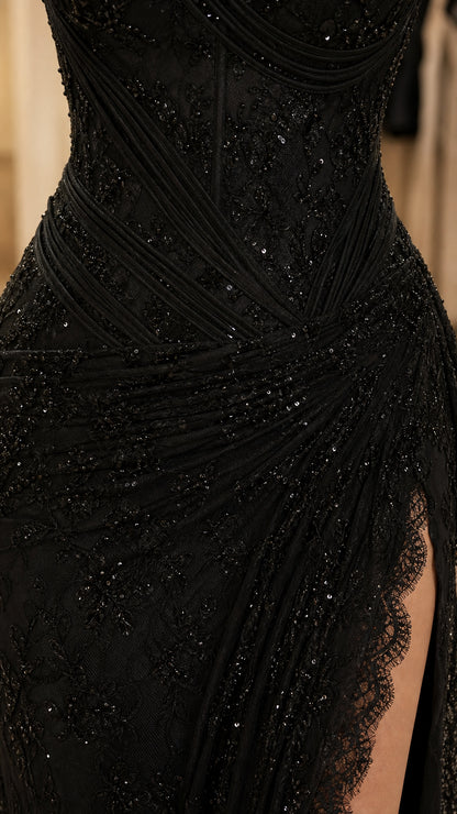 Close-up detail of sequin embroidery and lace trim on high slit
