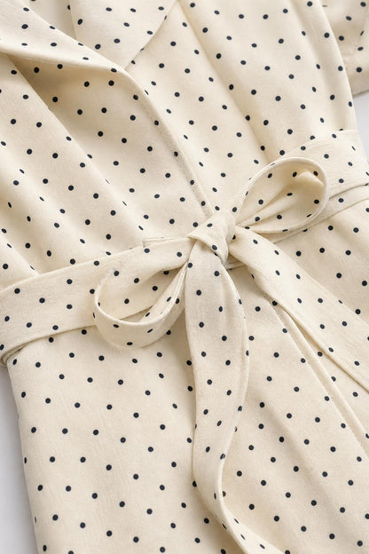 Close-up of polka dot fabric pattern and waist tie detail