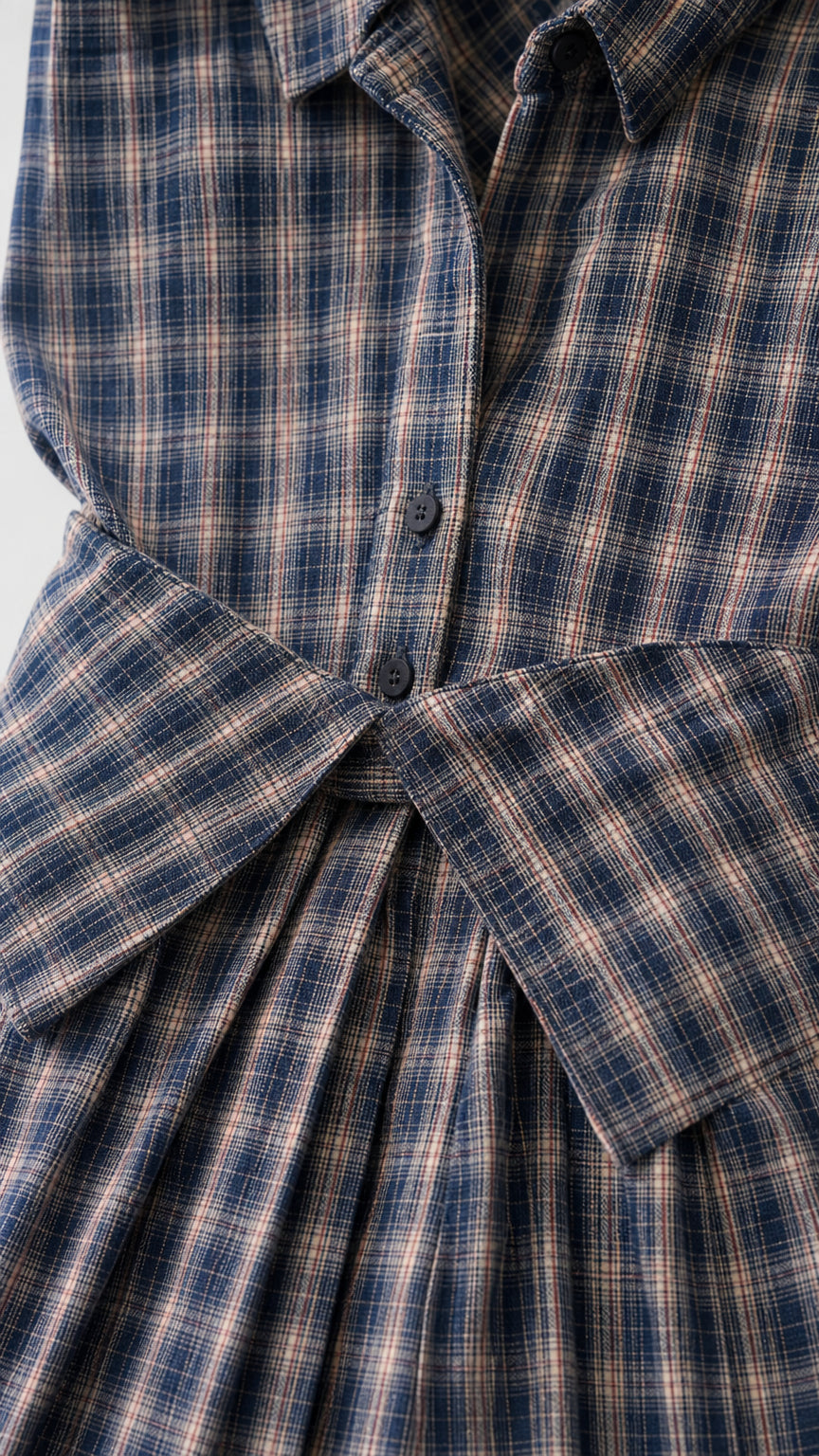 Close-up detail of collar, button placket, and waist tie
