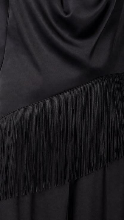 Close-up detail of fringe trim on black satin jumpsuit