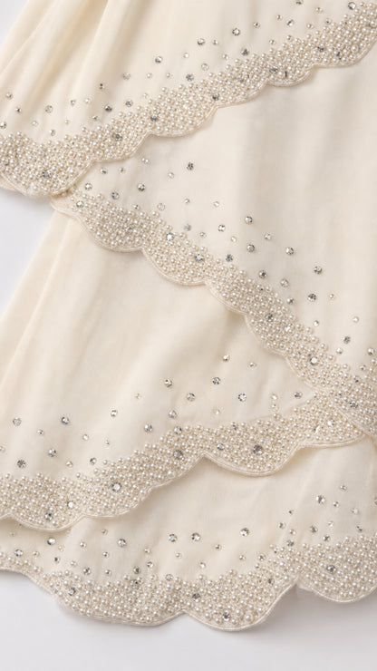 Close up detail of beaded scalloped tiers