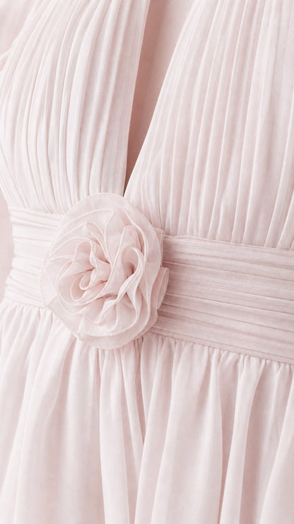 Close-up detail of front bodice rosette and chiffon pleats on pink dress
