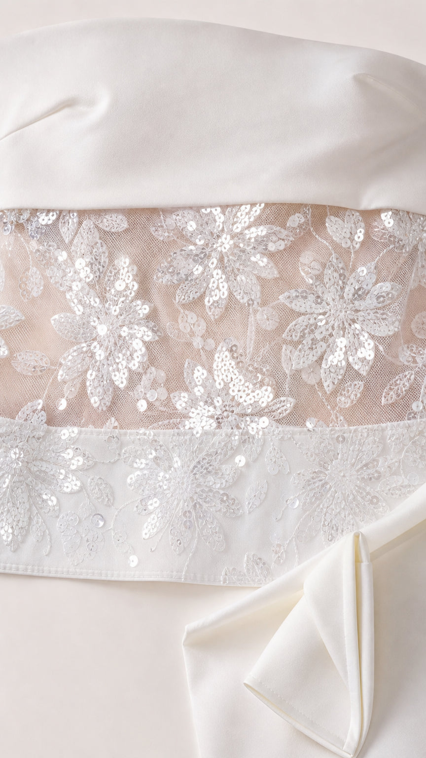 Close up detail of floral sequin embroidery on sheer mesh fabric