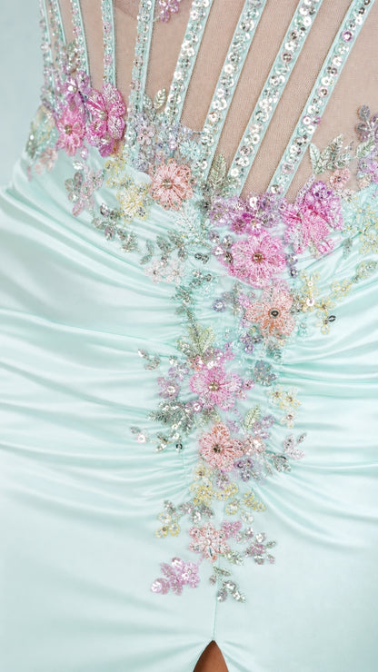 Close-up of floral applique and beadwork on mint dress