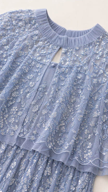 Close up of neckline and sequin details on light blue dress