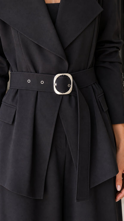 Close-up detail of blazer lapel and silver buckle belt