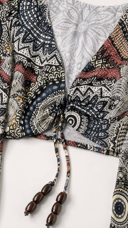 Close-up detail of the tie-front V-neck crop top with beaded tassels
