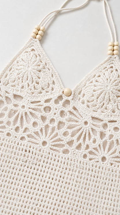 Close-up detail of white crochet halter neckline with wooden beads