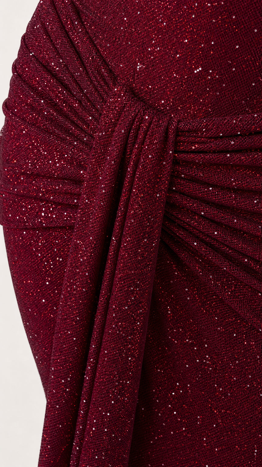Close-up of ruched draping on burgundy glitter evening dress